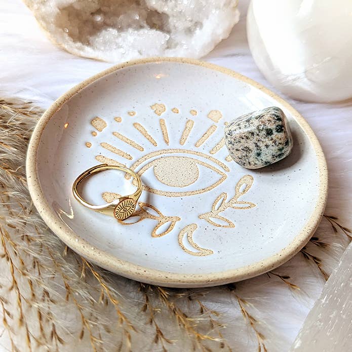 Evil Eye Adjustable Gold Ring on a ring dish with Dalmatian jasper