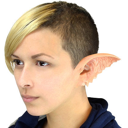 Person wearing a large, detailed elf ear costume on a white background