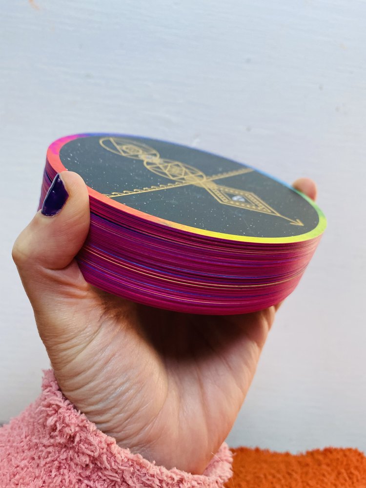 This is a picture of the creator of the Sacred Revolution Multi Media Oracle Deck holding her own cards