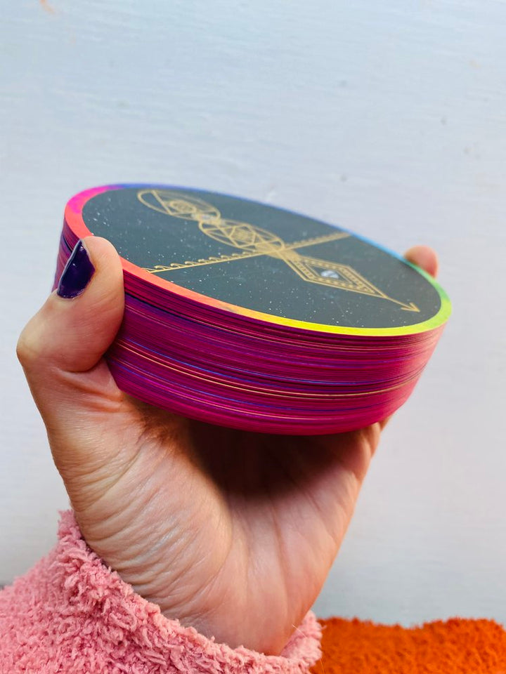This is a picture of the creator of the Sacred Revolution Multi Media Oracle Deck holding her own cards