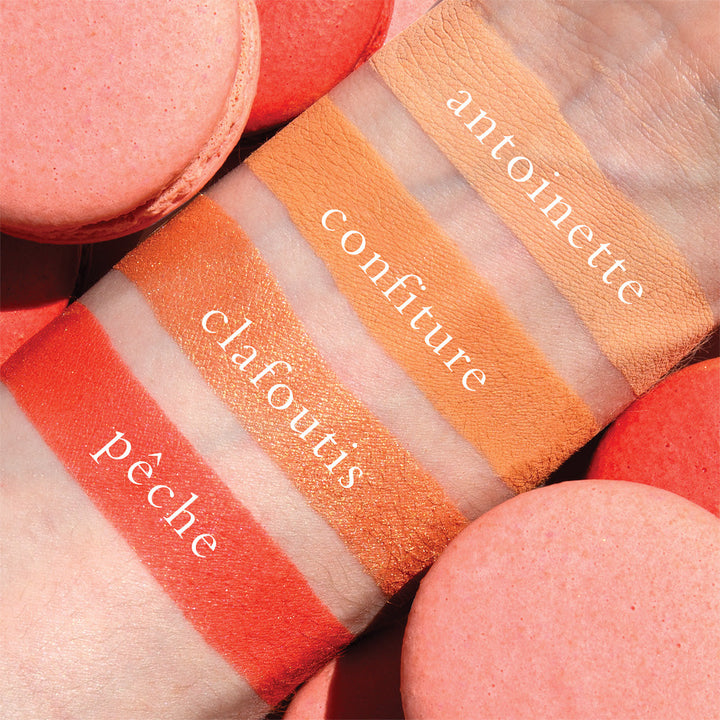 The Petits Fours Peche pallet swatched and labelled on a light skinned person  