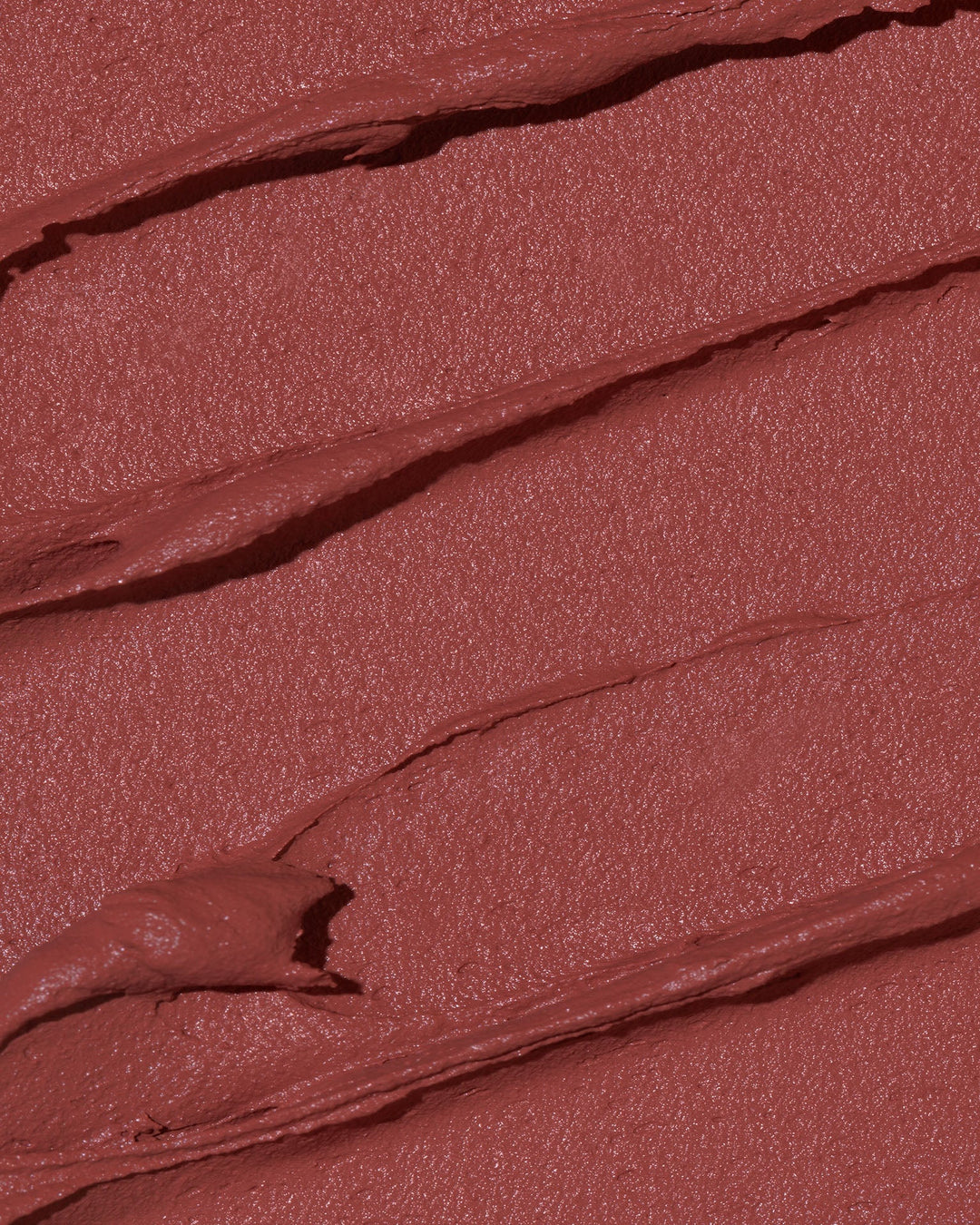 This is a swatch of the Peaking Velvet Mousse Lipstick. The color is like a mix of red/ brown/ and pink