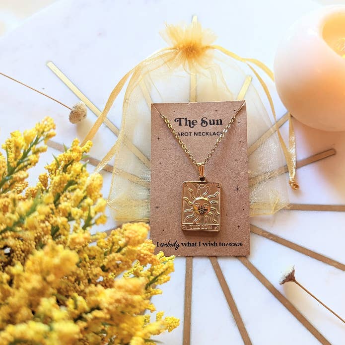 Tarot Sun Necklace in its packaging