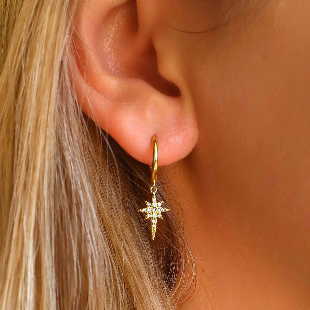 Gold Crystal Star Earrings on a model
