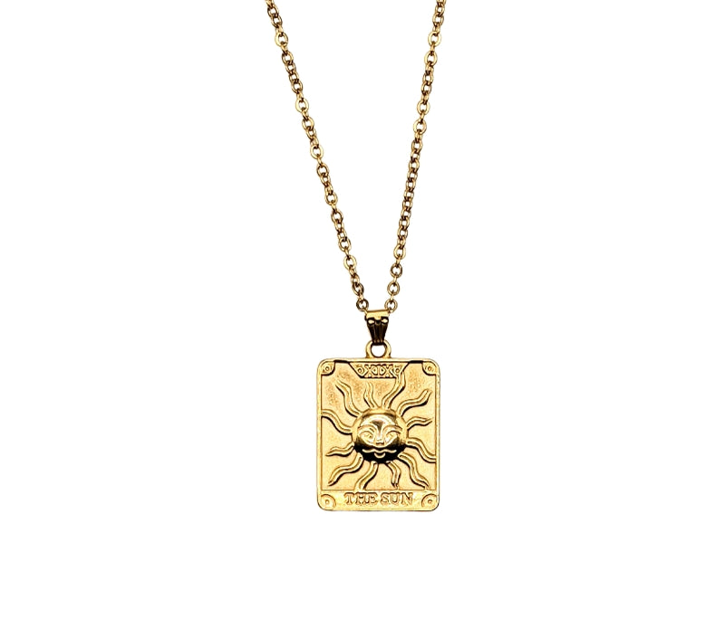 Tarot Sun Necklace hanging with a white background too see it without any distractions