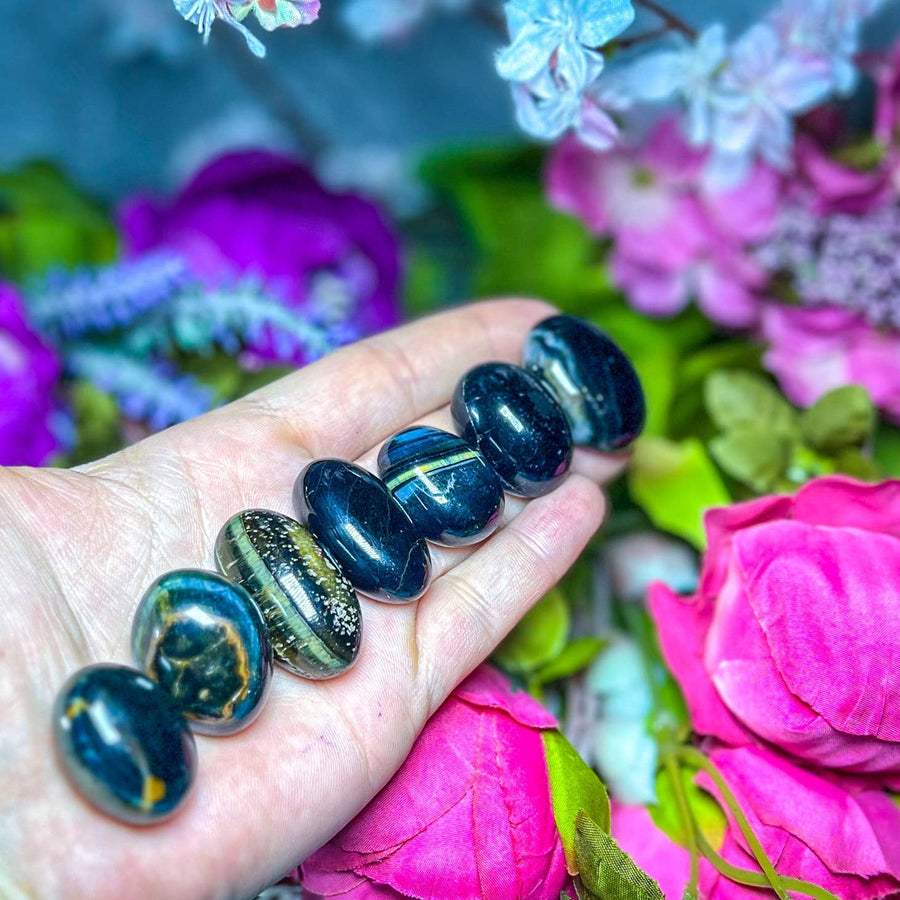 Blue Tigers Eye Tumblers in the palm of a hand