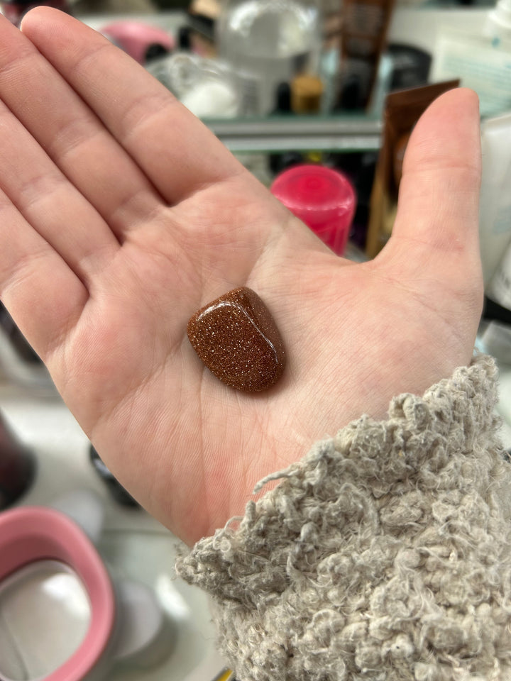 Goldstone Tumbler in a palm
