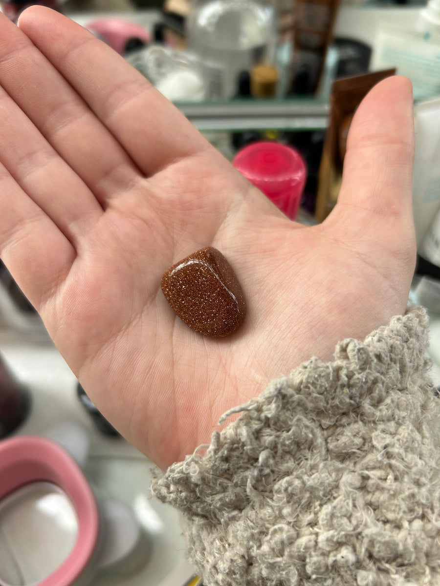 Goldstone Tumbler in a palm
