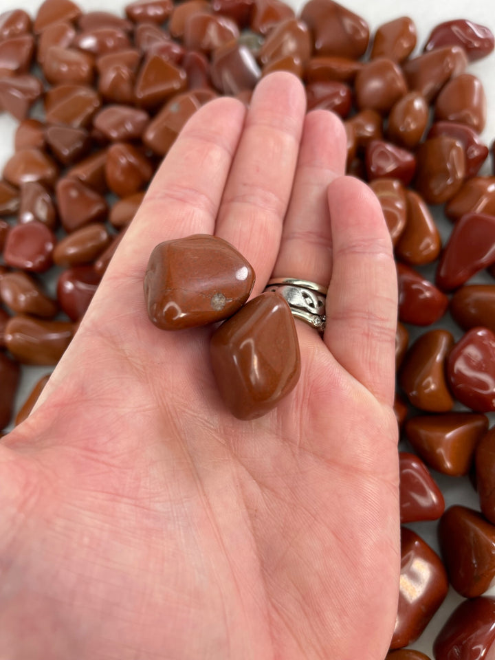 Red Jasper Tumblers in the palm of the hand