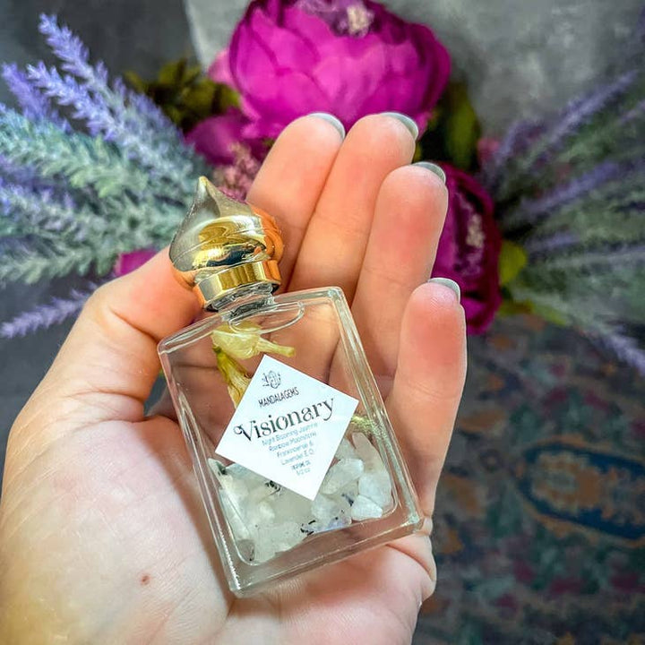 Jasmine Perfume Oil with Rainbow Moonstone crystals in the palm of a hand