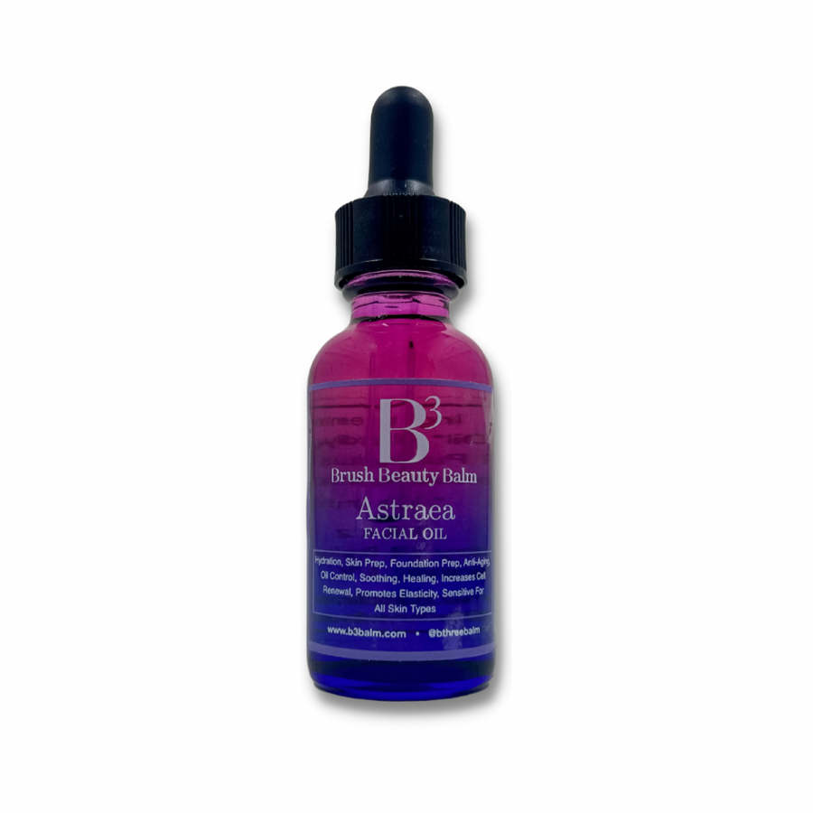 Picture of the Astraea Facial Oil showing the beautiful pink and blue glass bottle that has the oil name with different ways to use the oil