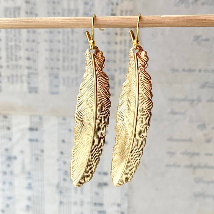 Feather earrings hanging ion wood stick