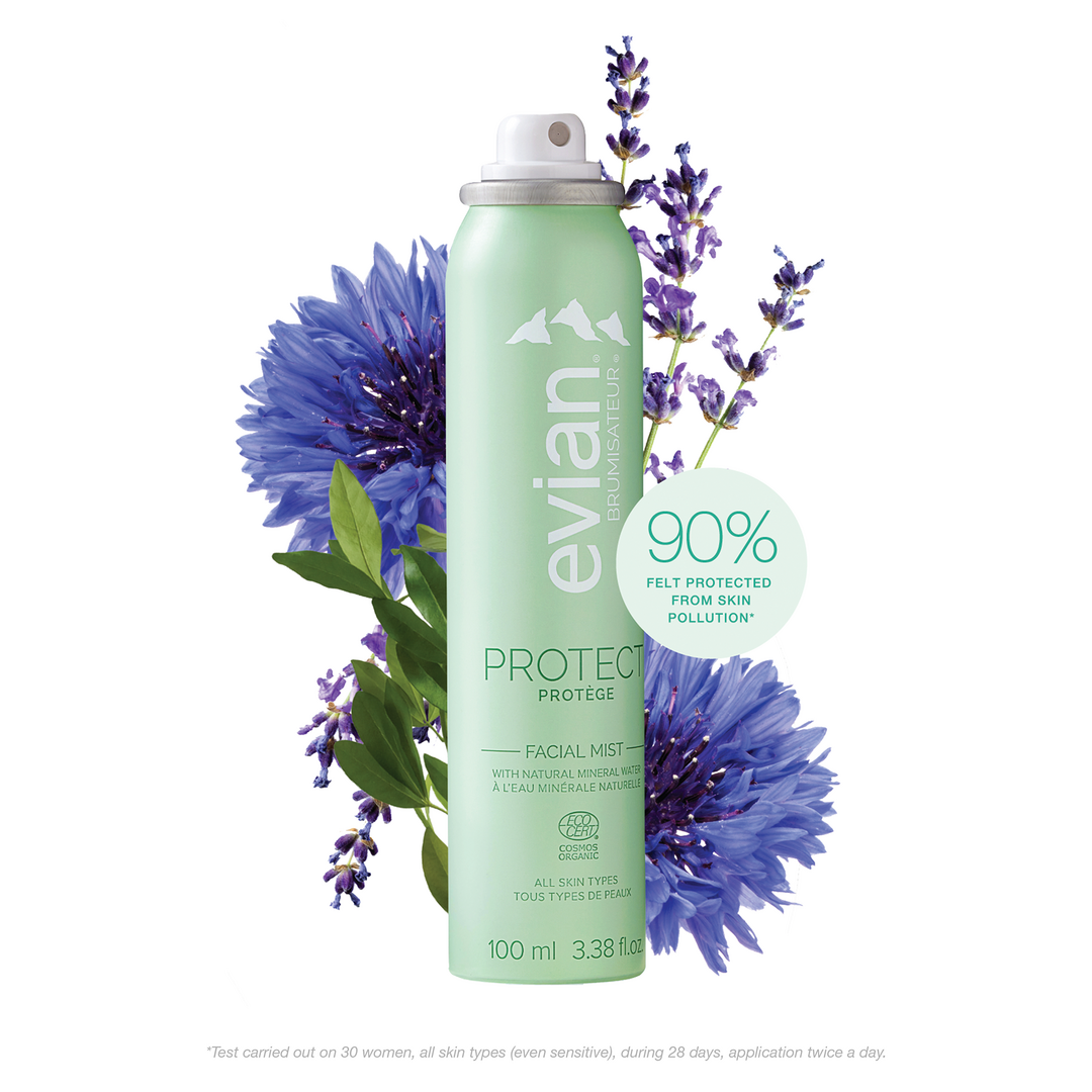 Evian facial mist bottle with lavender and cornflower flowers on a white background