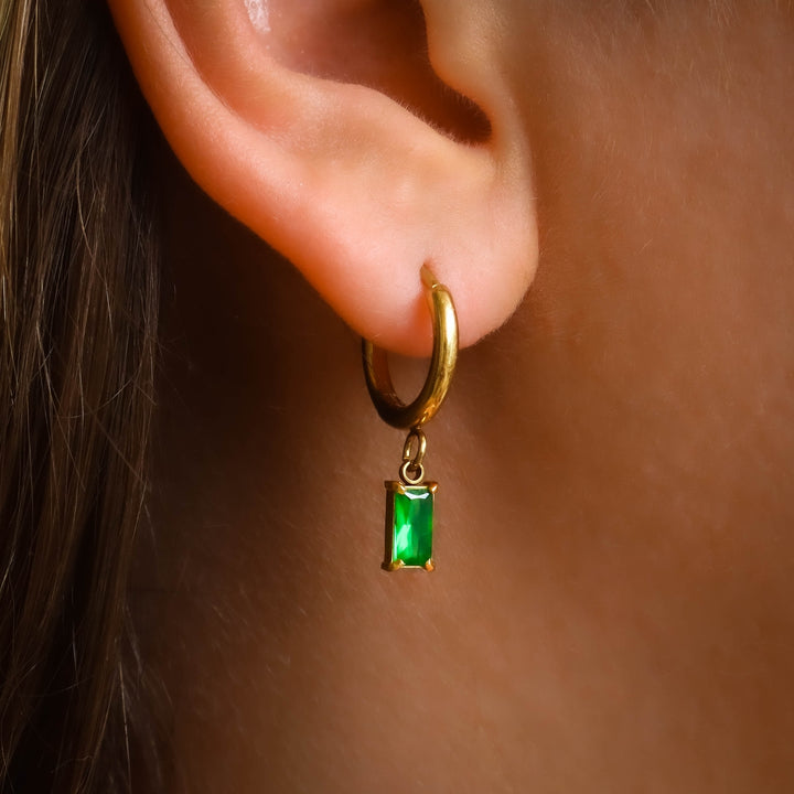 Emerald Dangle Earrings on a model close up