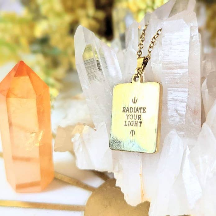 the back of the Tarot Sun Necklace that says radiate your light