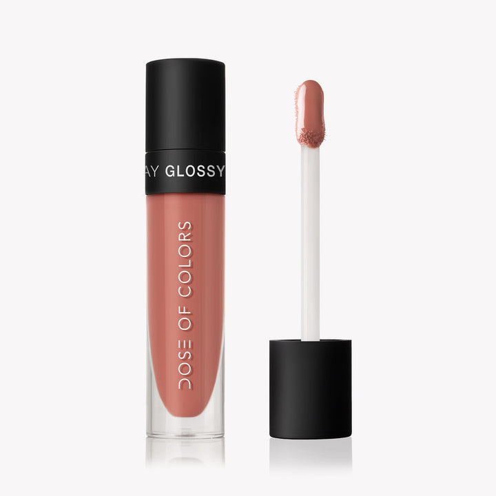 Picture of the Almond Butter Lip Gloss from dose of color. A clear bottle with a black cap accented by the white lettering makes this look so smooth 