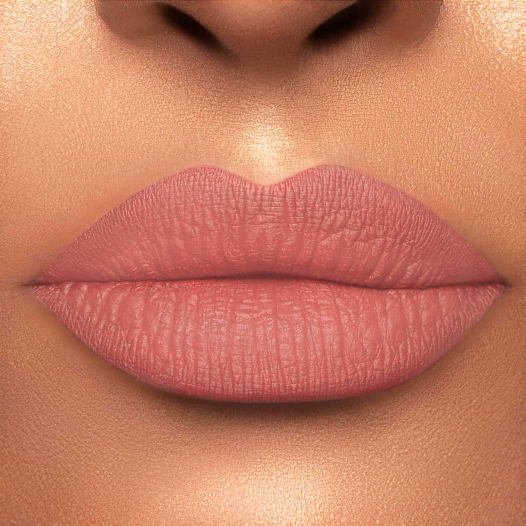 This is a light skin tone lip swatch of the Bare With Me  Liquid Matte Lip.