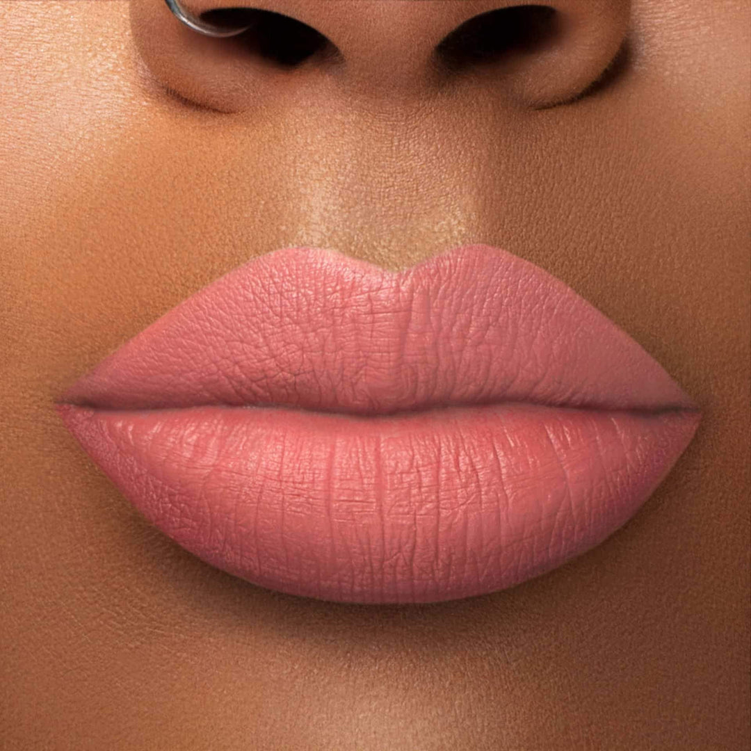 This is a medium skin tone lip swatch of the Bare With Me Liquid Matte Lip.