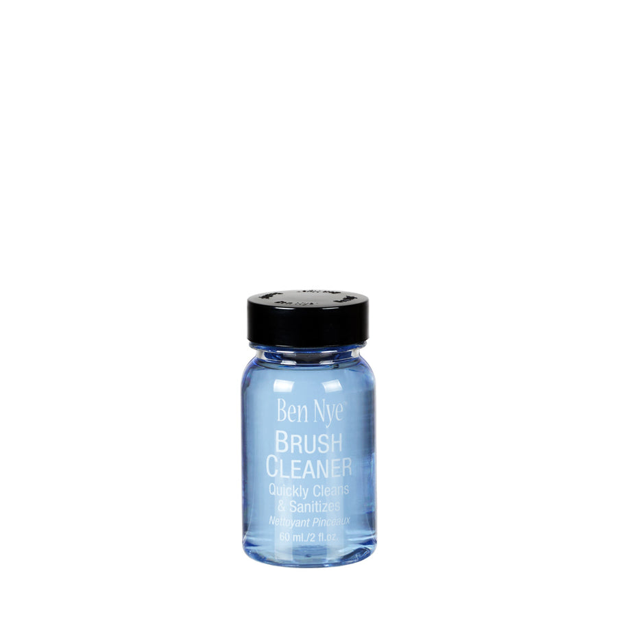 Blue bottle of Ben Nye Brush Cleaner with black cap on a white background
