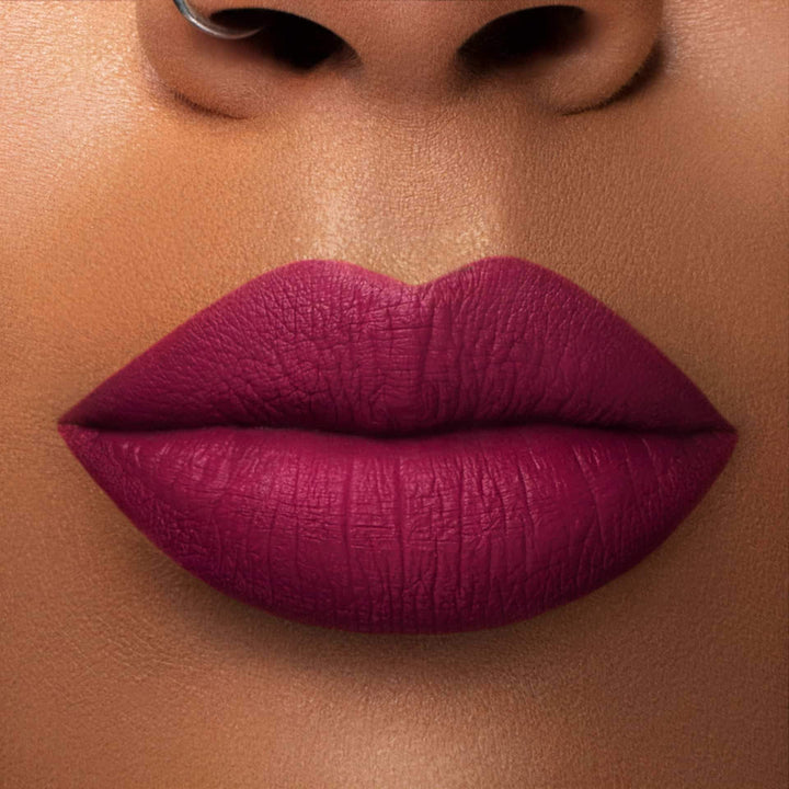 This is a medium skin tone lip swatch of the Berry Me Liquid Matte Lip.