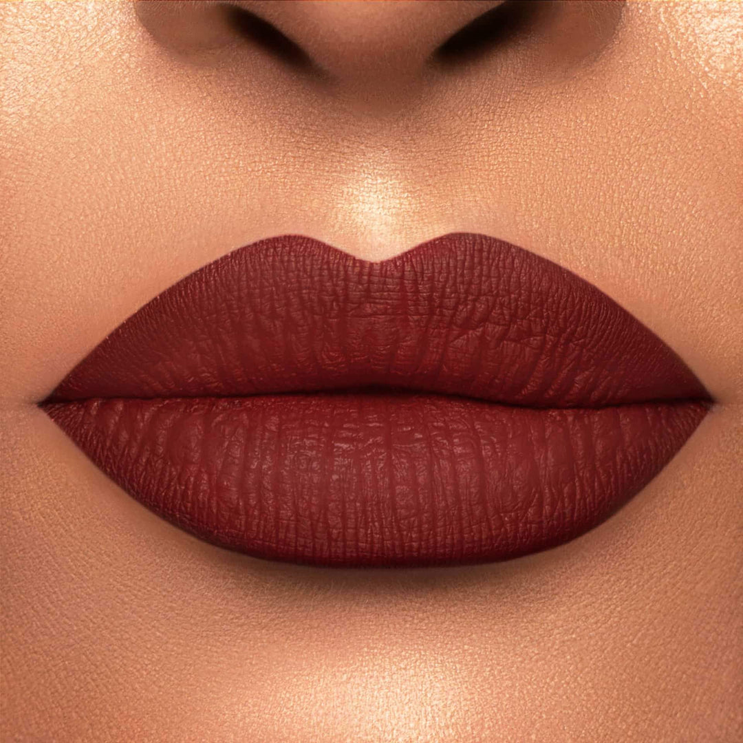 This is a light skin tone lip swatch of the Brick Liquid Matte Lip.