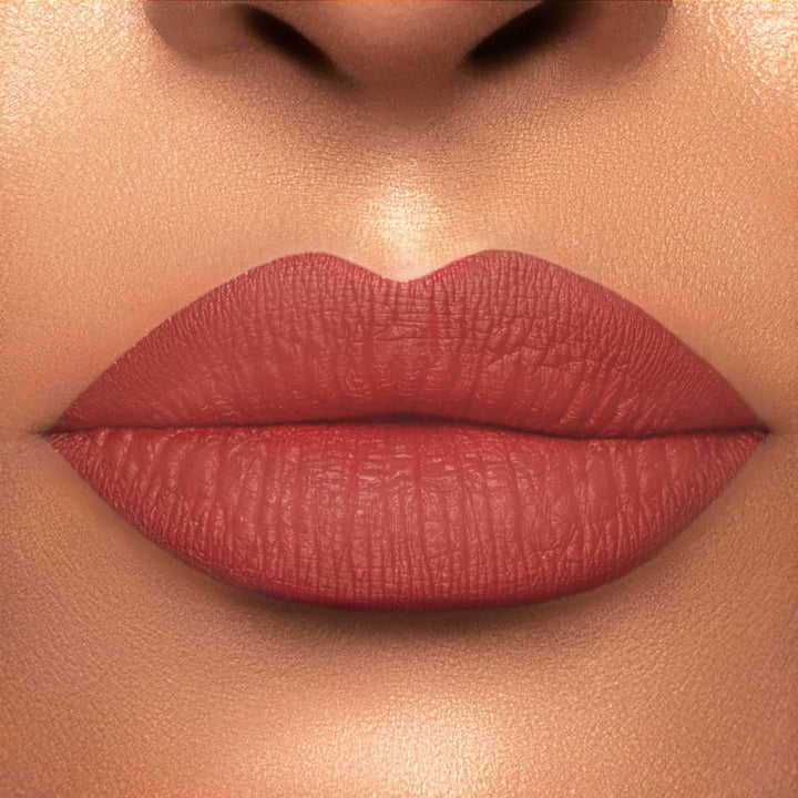 This is a light skin tone lip swatch of the Campfire Liquid Matte Lip.