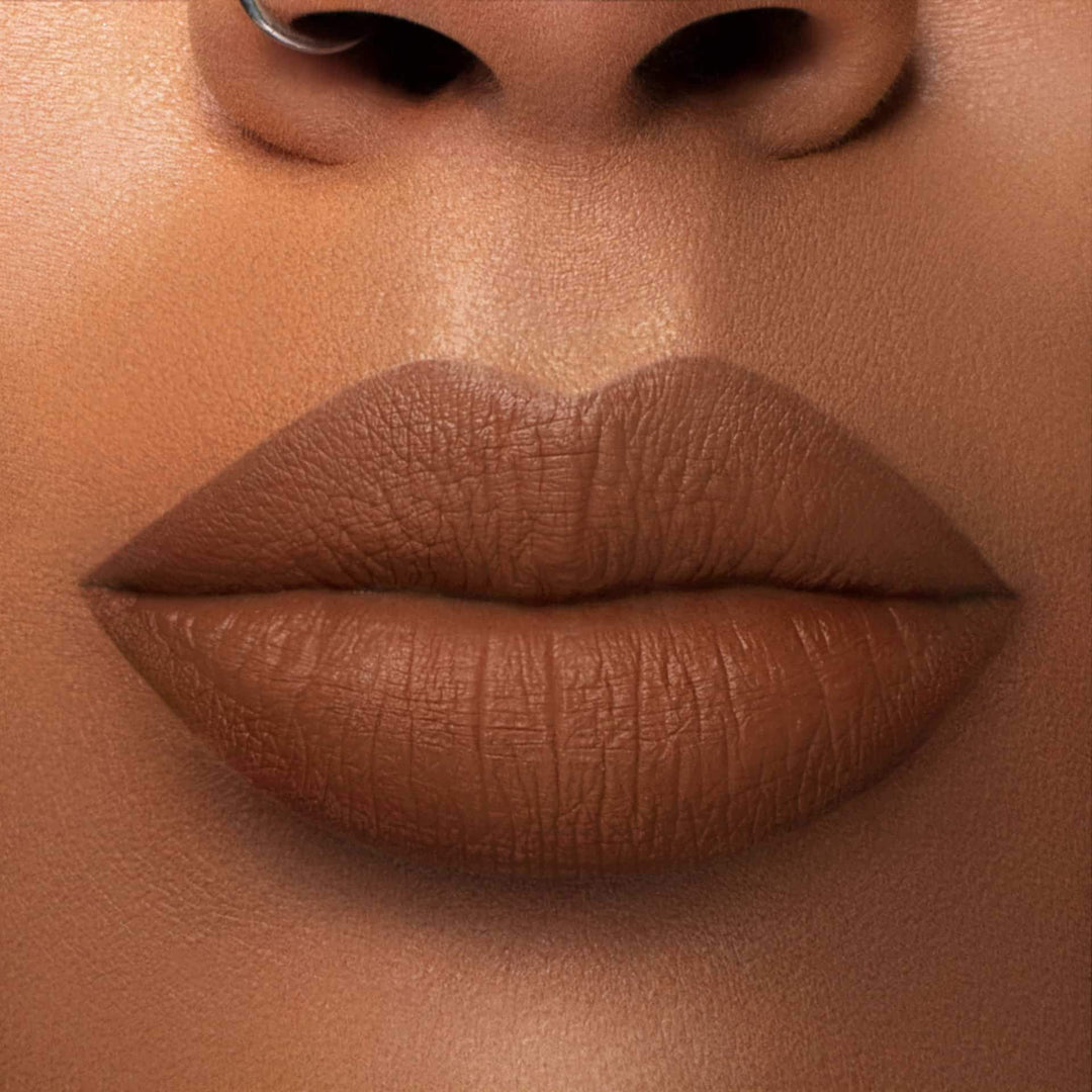 This is a medium skin tone lip swatch of the Cork Liquid Matte Lip.