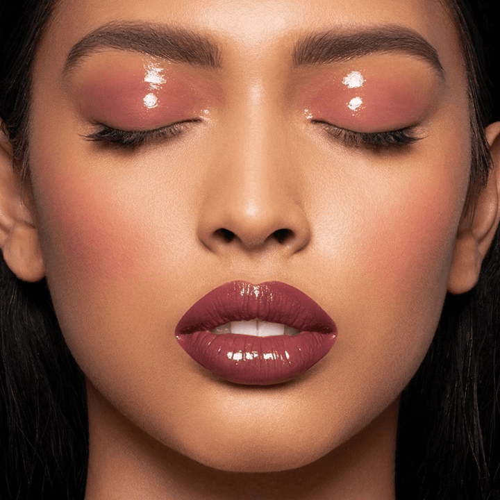 This is a model wearing the desert rose shade of the color fix mattes with a clear glaze on top of the lips and eyes. She is wearing this shade as blush, eye shadow and lipstick.