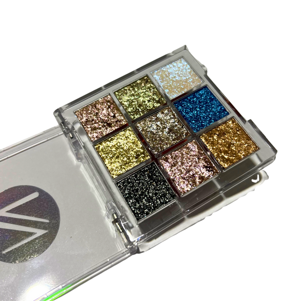 Makeup palette with glittery shades on a white background