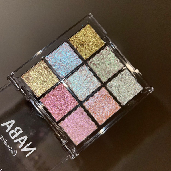 Makeup palette with glittery eyeshadows on a dark background