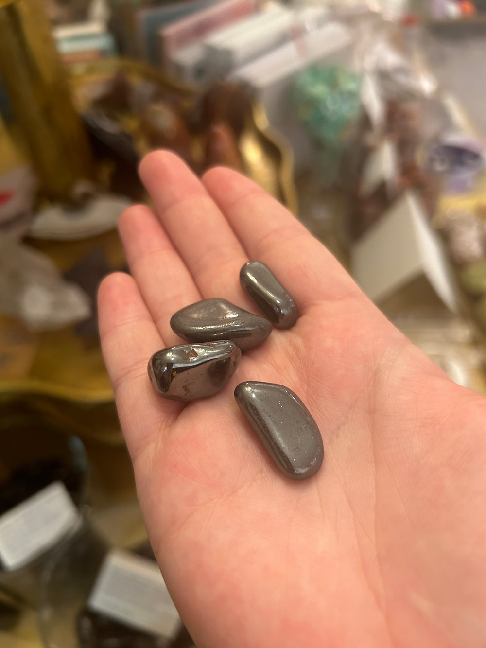 Hematite Tumblers in palm of hand 