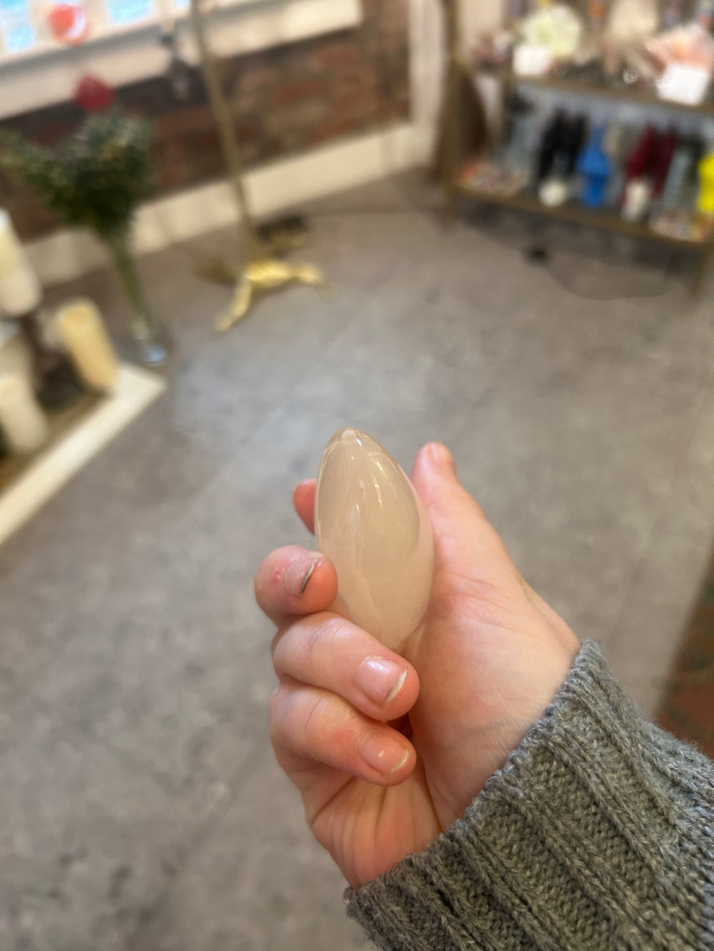Selenite Palm Stone in palm with the side view