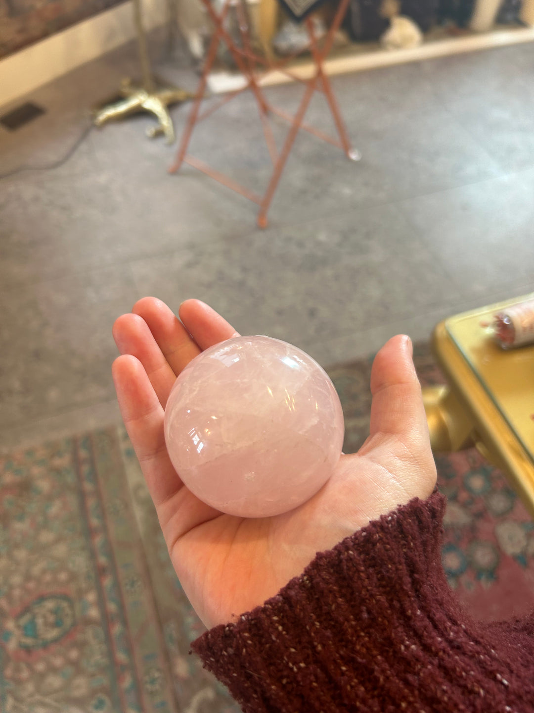 Medium Rose Quartz Sphere in the palm of a hand
