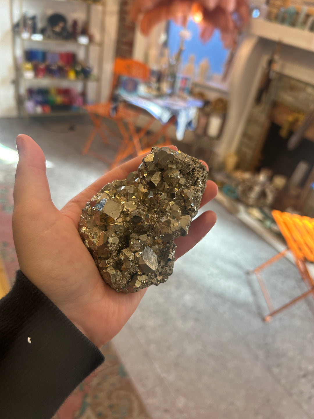 Large Pyrite Cluster being held in different writing