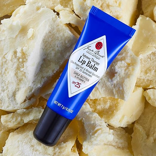 Blue lip balm tube on a background of shea butter chunks