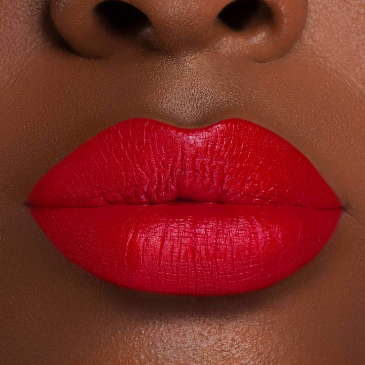 This is a dark skin tone lip swatch of the Kiss of Fire Liquid Matte Lip.