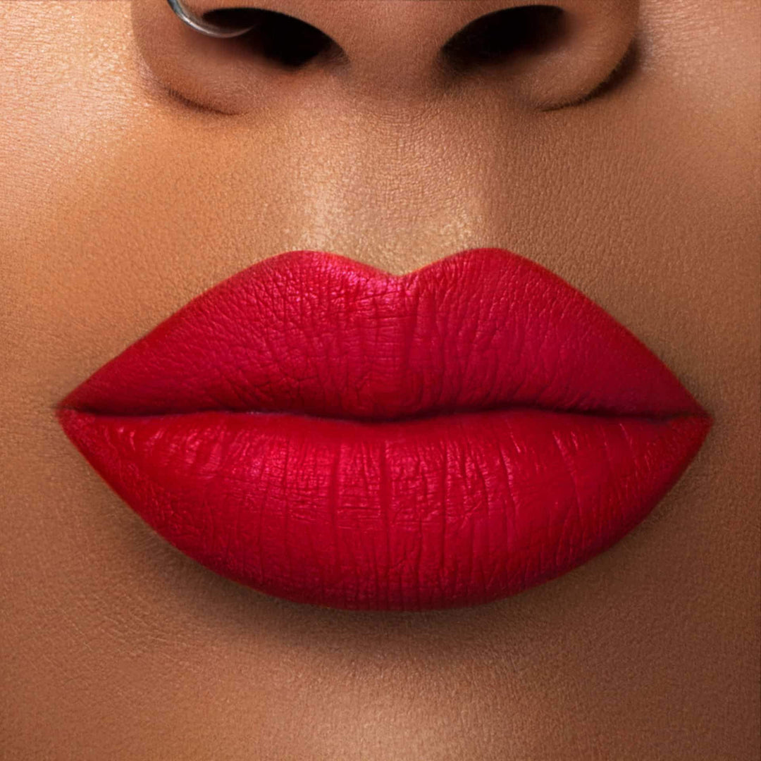 This is a medium skin tone lip swatch of the Kiss of Fire Liquid Matte Lip.