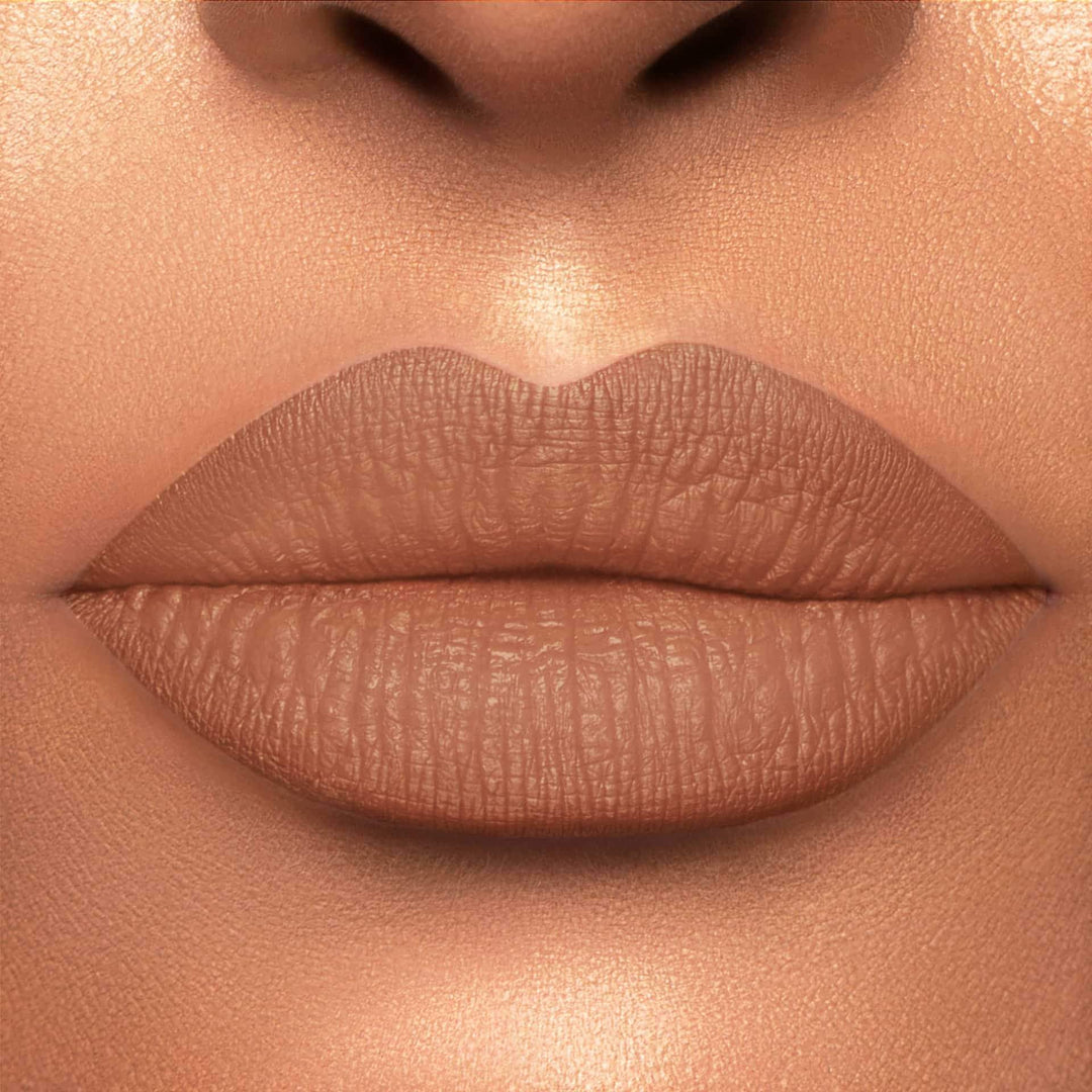 This is a light skin tone lip swatch of the Knock on Wood  Liquid Matte Lip.