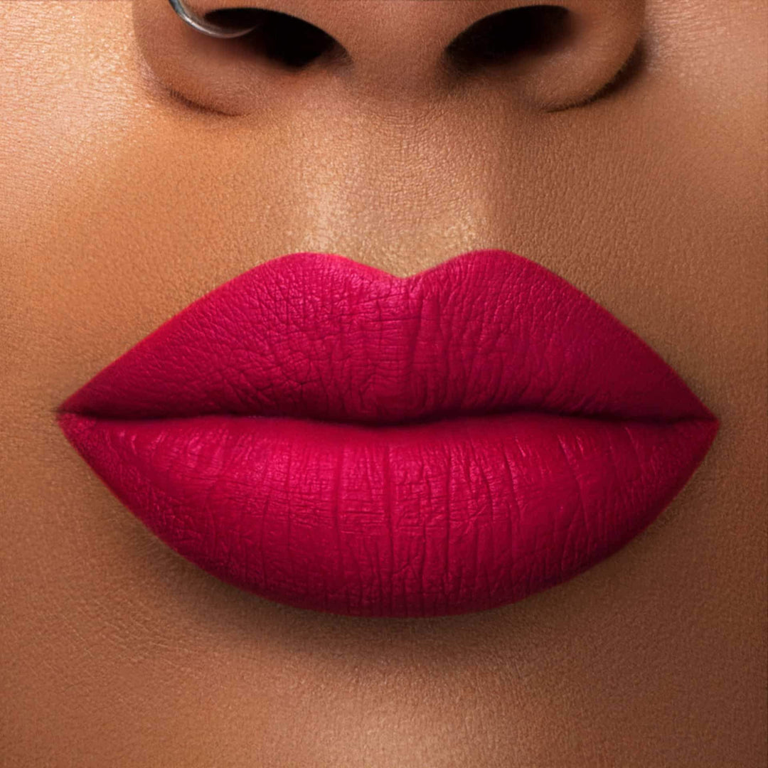 This is a medium skin tone lip swatch of the Merlot Liquid Matte Lip.