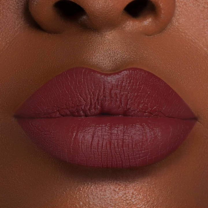 This is a dark skin tone lip swatch of the Mood Liquid Matte Lip.