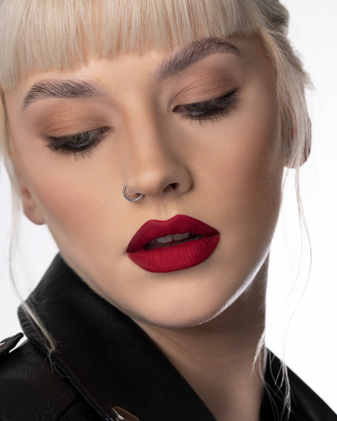 A model wearing the red Out of office Velvet Mousse Lipstick