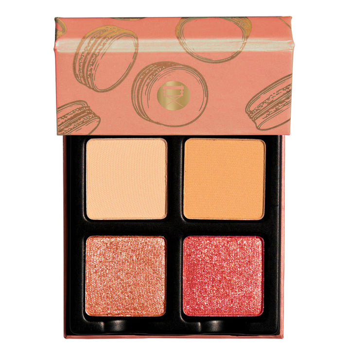  The Petits Fours Peche pallet open showing the shimmering orange and red with the matte cream and orange colors. You get a glimpse of the outside which is a peachy color that has gold macaroons.