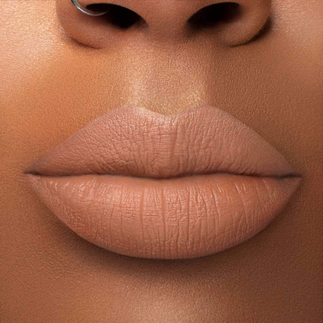 This is a medium skin tone lip swatch of the Supernatural Liquid Matte Lip.