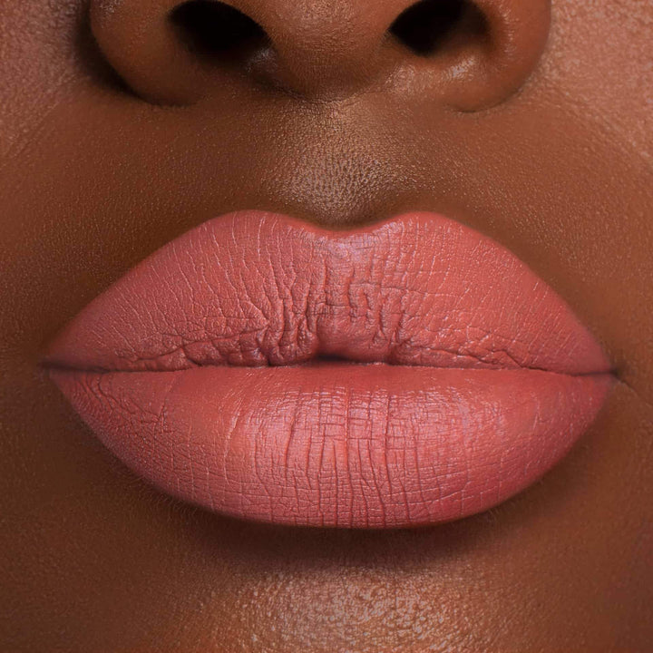 This is a dark skin tone lip swatch of the Warm & Fuzzy Liquid Matte Lip.