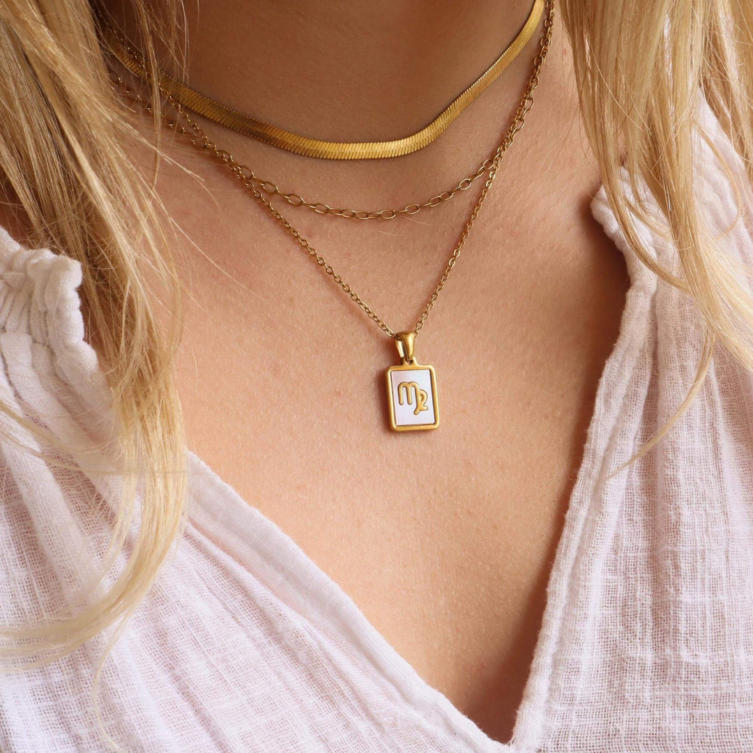 zodiac necklaces on model