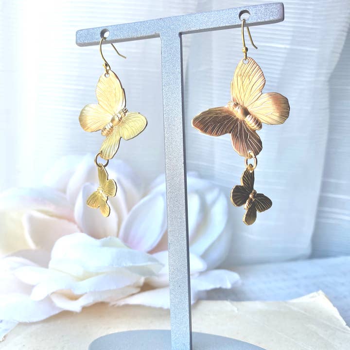 Butterfly earrings hanging on a stand