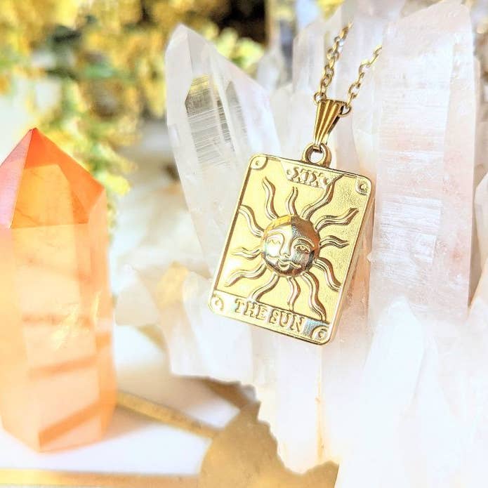 Tarot Sun Necklace hanging on quartz