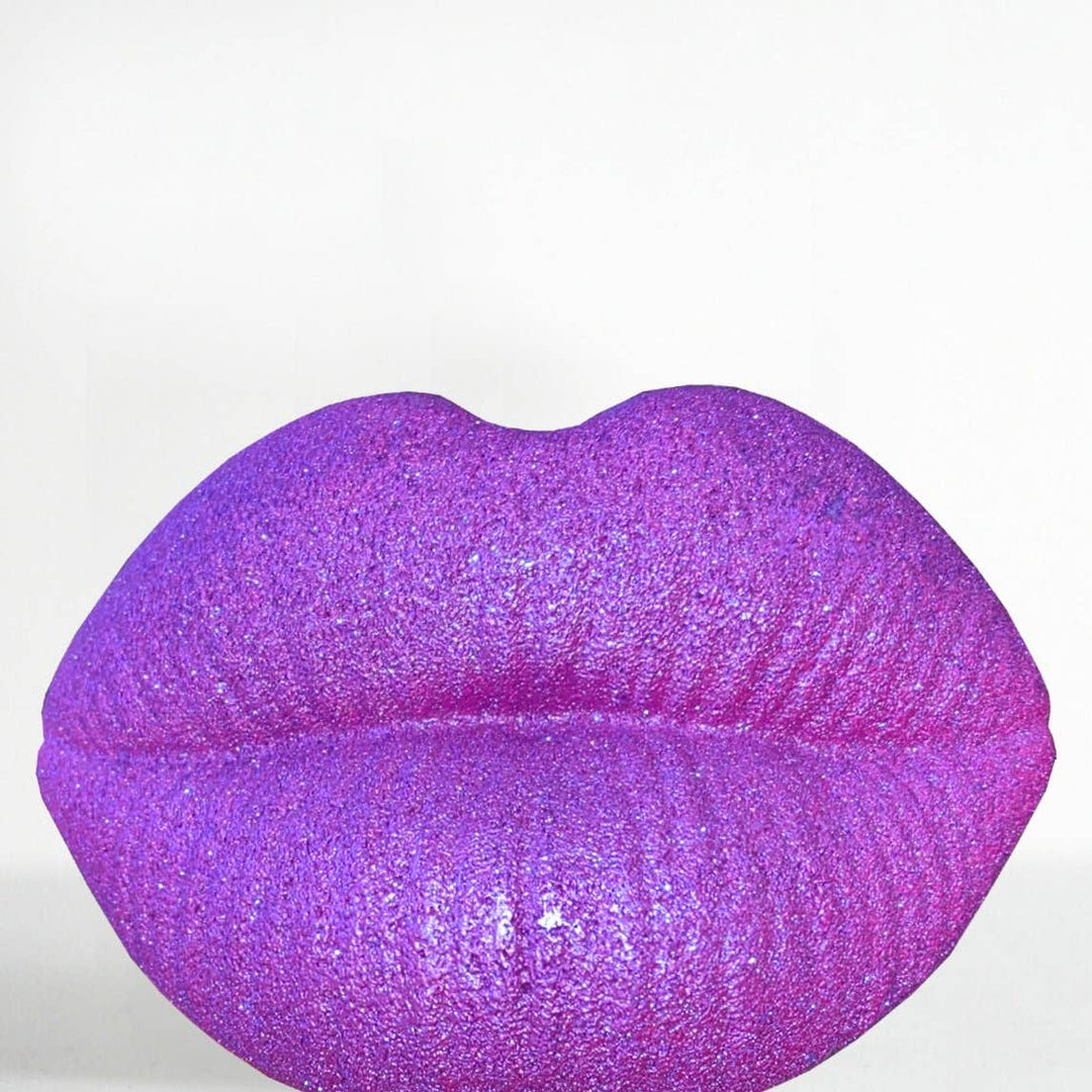purple lips bath bomb with a bloodstone in the bath bomb. 