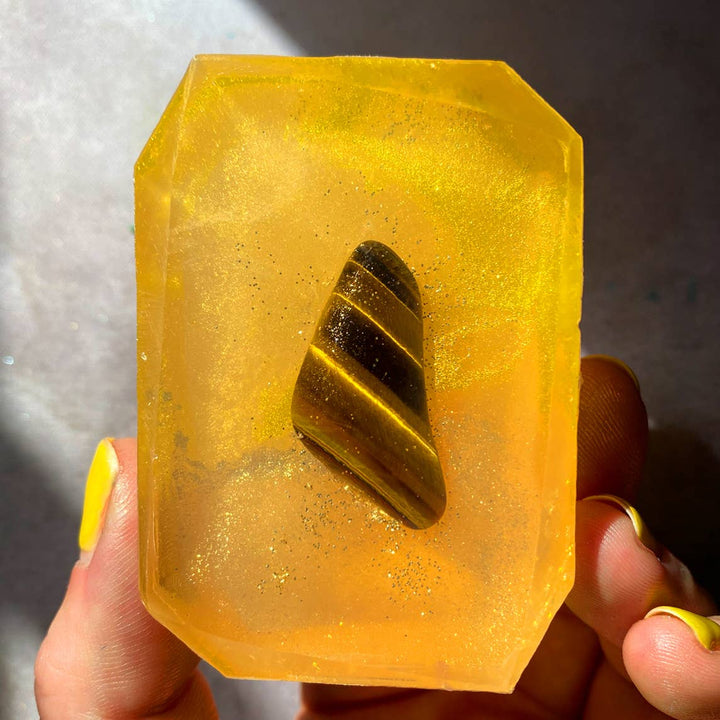 Attracting Wealth - Crystal Infused Bar Soap with an embedded tigers eye being held