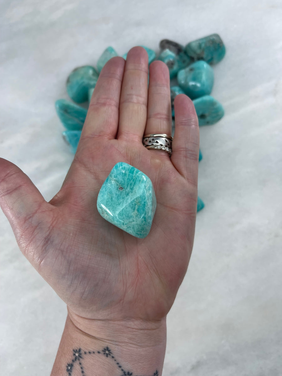 Amazonite tumbler in a palm for a size reference